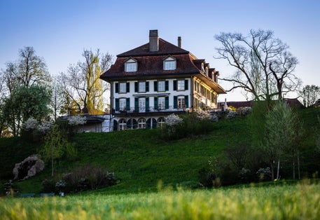 photo of old house in morning light in Elfenaupark in Bern, Switzerland.