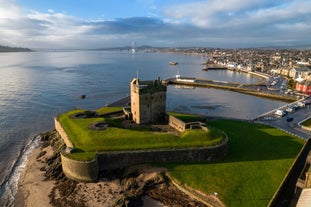 Photo of aerial view of Aberdeen as River Dee flows in a curve to the North Sea showing Duthie Park with bridge and traffic from south.