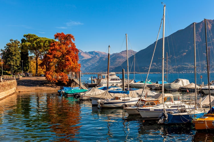 Photo of boats and yachts on Lake Maggiore in autumn in Locarno, Switzerland.