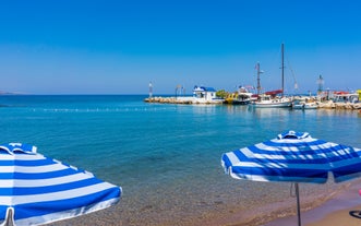 Photo of panoramic aerial view of Lindos bay, village and Acropolis, Rhodes, Greece.