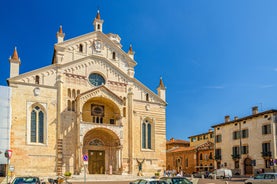 Photo of aerial view of Verona historical city centre, Ponte Pietra bridge across Adige river, Verona Cathedral, Duomo di Verona, red tiled roofs, Veneto Region, Italy.