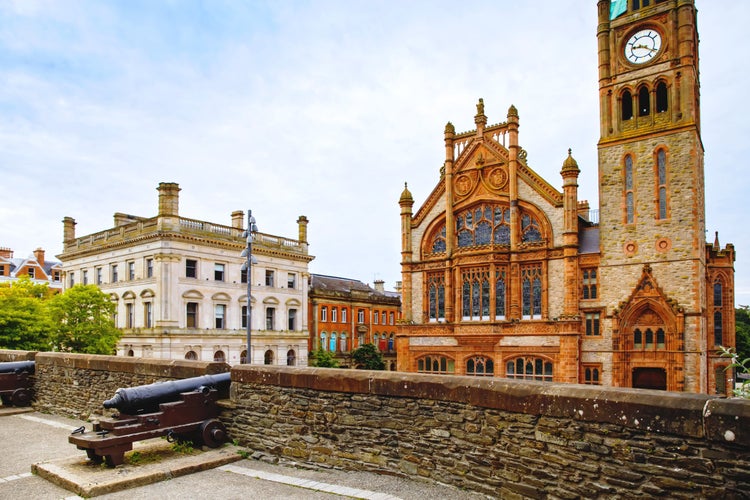 photo of view of Derry, North Ireland. Aerial view of Derry Londonderry city center in Northern Ireland, UK. Sunny day with cloudy sky, city walls and historical buildings.