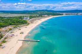 Photo of Saint Anastasia Island in Burgas bay, Black Sea, Bulgaria. Lighthouse tower and old wooden buildings on rocky coast.