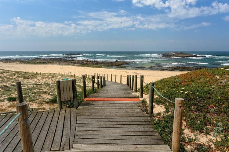 End of wooden walkway over dune giving access to a beautiful deserted beach in northern Portugal