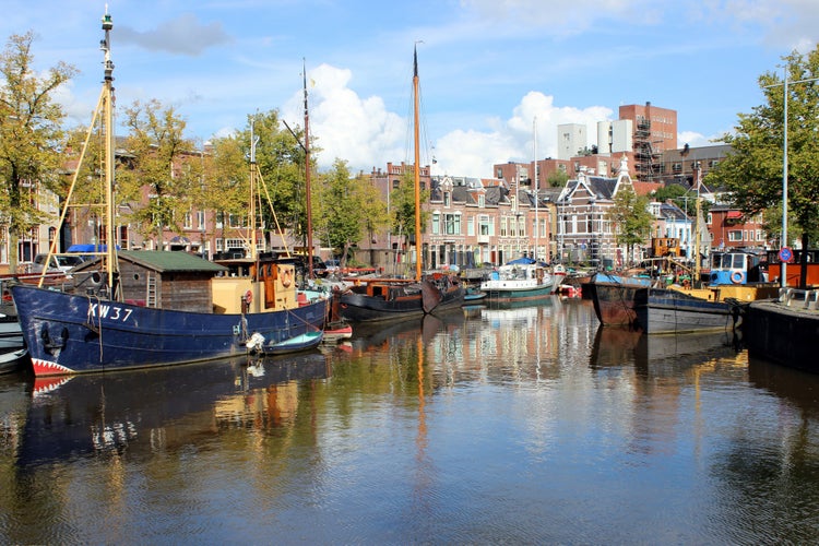 GRONINGEN, NETHERLANDS - Panorama of historic ships and warehouses at the canal in Groningen, Netherlands