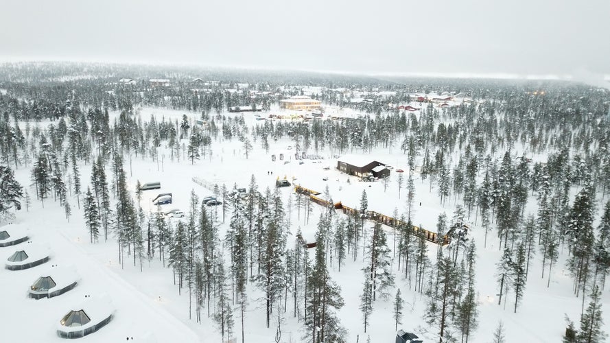 photo of Saarisalkae, Finland in beautiful white snow covered, Northern lights village hotel cabins in Northern Europe where people come to visit northern lights.