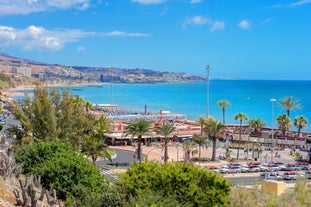 photo of landscape with Maspalomas town and golden sand dunes at sunrise, Gran Canaria, Canary Islands, Spain.