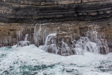 photo of Waves breaking on the cliffs - Downpatrick Head, Country Mayo, Ireland .
