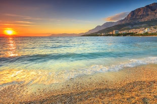 Photo of panorama and landscape of Makarska resort and its harbour with boats and blue sea water, Croatia.