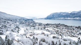 photo of Annecy city center panoramic aerial view with the old town, castle, Thiou river and mountains surrounding the lake, beautiful summer vacation tourism destination in France, Europe.