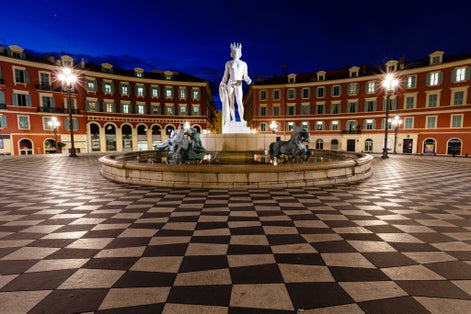 photo of The Fontaine du Soleil on Place Massena in the night in Nice, French Riviera, France.