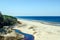 photo of the white dune and baltic see at saulkrasti in spring, Latvia. White sand beach near conifer trees forest in baltic.