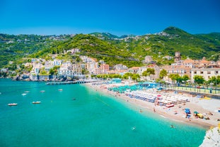 Naples, Italy. View of the Gulf of Naples from the Posillipo hill with Mount Vesuvius far in the background and some pine trees in foreground.