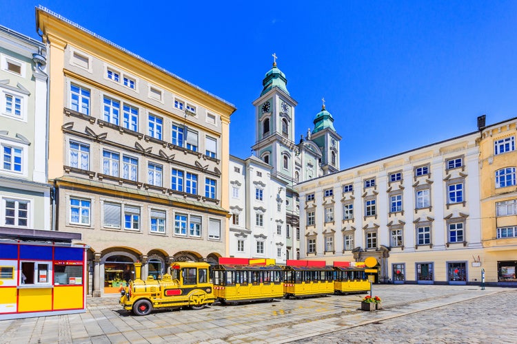 Photo of old Cathedral (Alter Dom) and tourist train in the Main Square, Linz, Austria. 