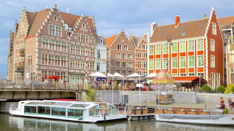 Photo of Grasbrug (bridge) across Leie River, Tourists going from one shopping district to another across small bridge in Ghent city centre, Belgium.