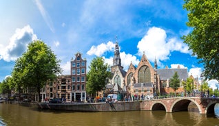 Amsterdam Netherlands dancing houses over river Amstel landmark in old european city spring landscape.