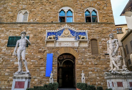photo of A copy of Michelangelo's David and Bartolommeo Bandinelli's Hercules and Cacus by Palazzo Vecchio on Square Piazza della Signoria in Florence, Italy .