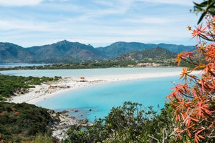 photo of an aerial view of Cagliari, in Sardinia, Italy, with the Montelargius lake and Quartu Sant Elena in the background.