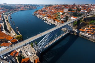 Porto, Portugal old town ribeira aerial promenade view with colorful houses, Douro river and boats.