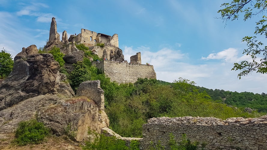 Panoramic view of medieval castle ruins of Duernstein in Krems an der Donau, Lower Austria, Europe. Awarded wine region of Wachau along the Danube river. Red roofs of houses of town center