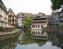 Photo of traditional half-timbered houses on picturesque canals in La Petite France in the medieval fairytale town of Strasbourg, France.