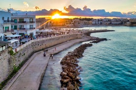 Photo of aerial view of Otranto town in Puglia with crystal turquoise waters, Italy.