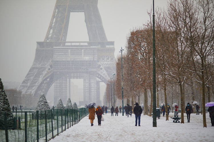 People passing by the Eiffel tower in Paris.jpg