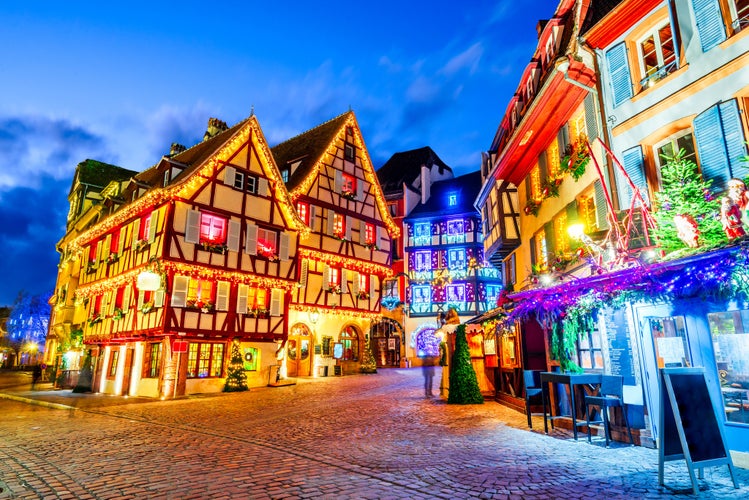 Photo of traditional Alsatian half-timbered houses Christmas decorated city in Alsace, Colmar, France.