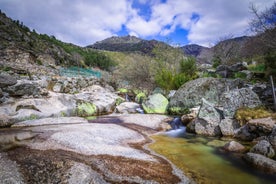 photo of Poço da Broca waterfall in Serra da Estrela Natural Park, Barriosa, municipality of Seia in Portugal, with a viewpoint in the foreground, at the end of a spring day.