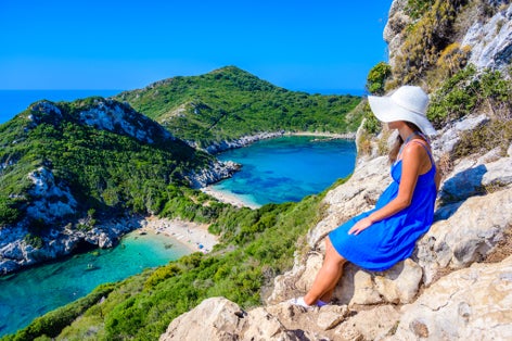 Photo of tourist with view of crystal clear azure water in Corfu.