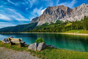 Photo of a view of the Alps from the Ehrwald, a town on the border of Germany and Austria with picturesque meadows surrounded by towering mountain ranges, including the Zugspitze.