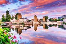 Photo of traditional half-timbered houses on picturesque canals in La Petite France in the medieval fairytale town of Strasbourg, France.