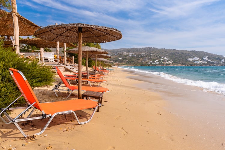 Photo of Plaka beach with crystal clear waters and the whitish sand. Naxos, Cyclades, Greece.