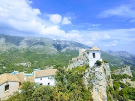 Photo of aerial panoramic view coastline and La Vila Joiosa Villajoyosa touristic resort townscape, sandy beach and Mediterranean seascape, Costa Blanca, Spain.