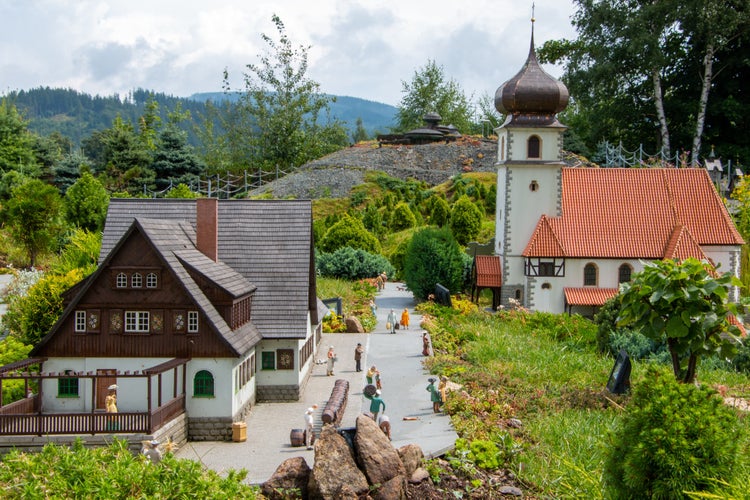 PHOTO OF VIEW OF Miniature models of church, traditional Silesian house and Sniezka mountain observatory at the Miniature Park in Kowary, Poland.