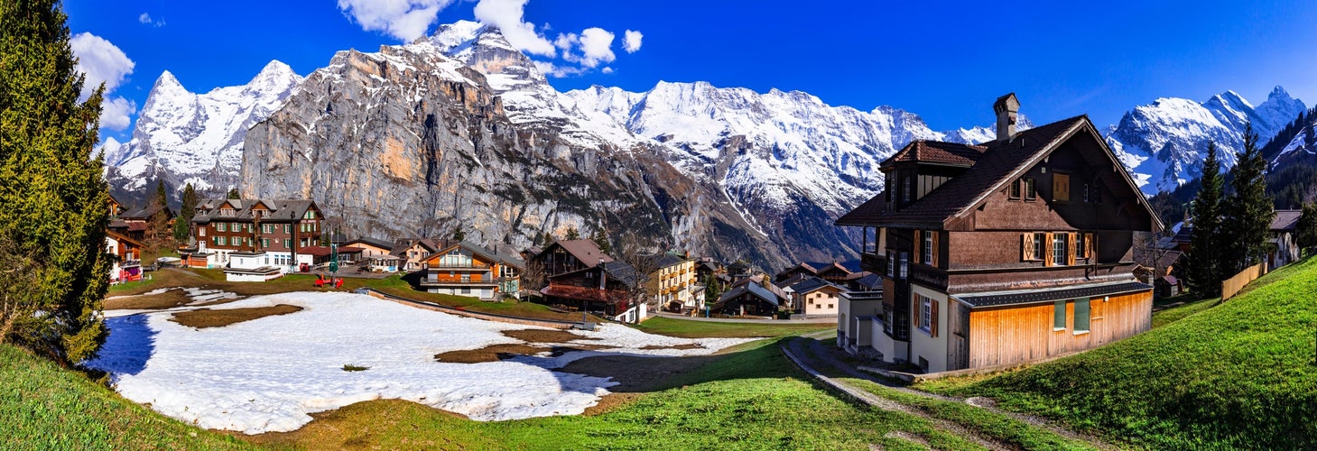 photo of Switzerland nature and travel. Alpine scenery. Scenic traditional mountain village Murren surrounded by snow peaks of Alps. Popular tourist destination and ski resort Lauterbrunnen.