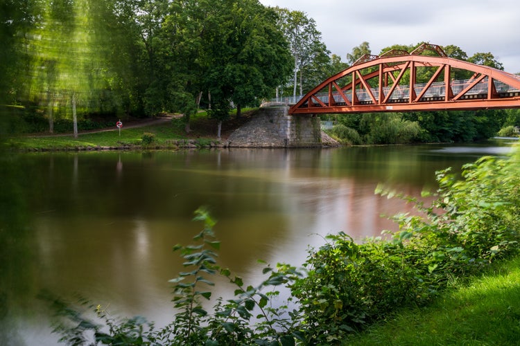 photo of  view  of Ronne river with beautiful green surroundings in the heart of Angelholm, Sweden. Photo taken close to the bridge Pyttebron. Selective focus.