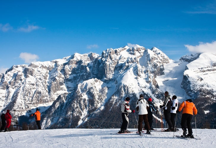 photo of people skiing in Ski Resort of Madonna di Campiglio in the Morning, Italian Alps, Italy.