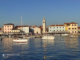 photo of an aerial view of the stunning Croatian coastal town of Pomer, with its picturesque oceanfront buildings and harbor.