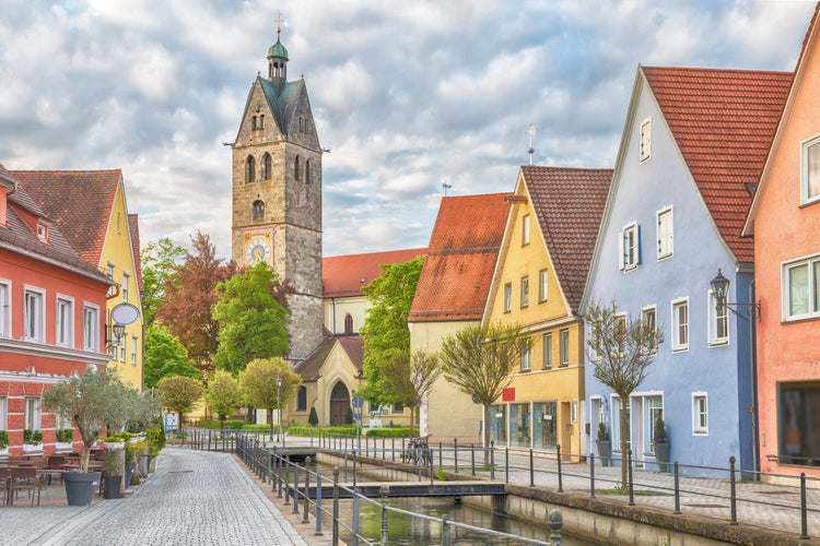 photo of colorful houses and bell tower of church of Our Lady in Memmingen, Bavaria, Germany.