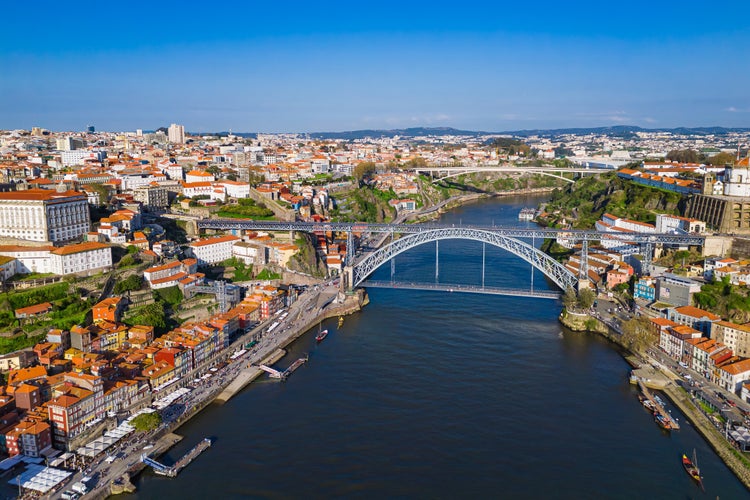 Photo of European city Porto with Luis I Bridge over Douro river in Portugal, aerial view.