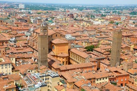 Photo of Italy Piazza Maggiore in Bologna old town tower of town hall with big clock and blue sky on background, antique buildings terracotta galleries.