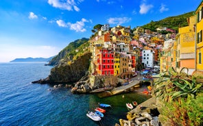 Photo of Riomaggiore with colorful houses along the coastline, one of the five famous coastal village in the Cinque Terre National Park, Liguria, Italy.