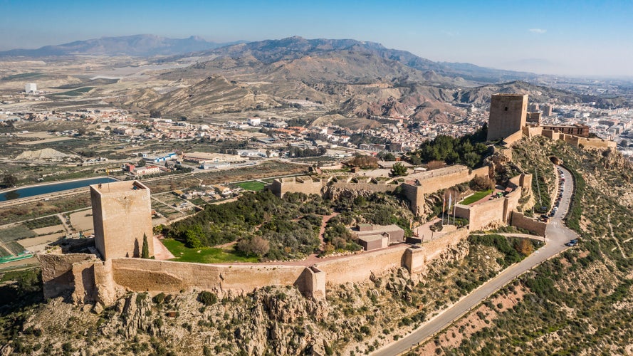 Photo of aerial view of Castle of Lorca on a sunny day, Spain.