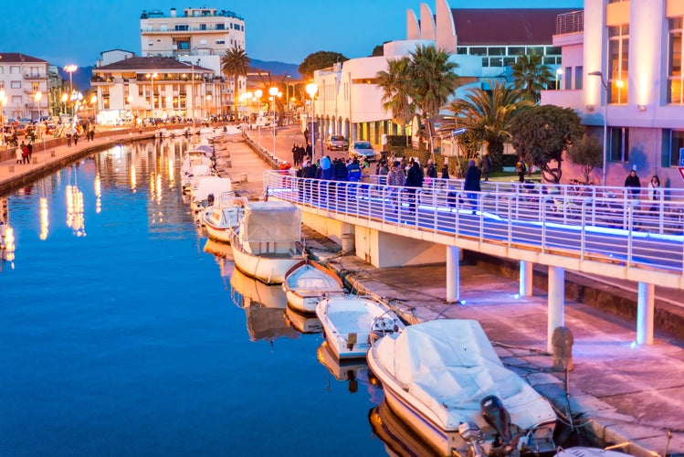 Viareggio, Tuscany. Boats along city canal at night.