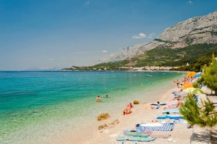 Photo of panorama and landscape of Makarska resort and its harbour with boats and blue sea water, Croatia.