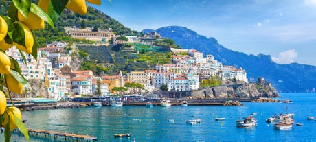 photo of aerial panorama of high cliffs, Tyrrhenian Sea Bay with pure azure water, floating boats and ships, pebble beaches, rocky surroundings of Meta in Sant'Agnello and Sorrento cities near Naples region in Italy.