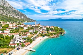 Photo of panorama and landscape of Makarska resort and its harbour with boats and blue sea water, Croatia.