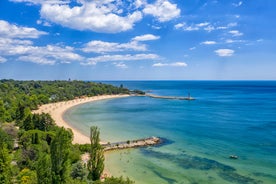 Photo of Saint Anastasia Island in Burgas bay, Black Sea, Bulgaria. Lighthouse tower and old wooden buildings on rocky coast.