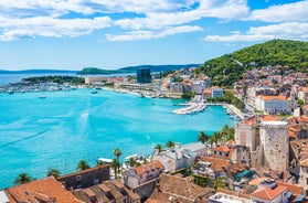 Photo of panorama and landscape of Makarska resort and its harbour with boats and blue sea water, Croatia.